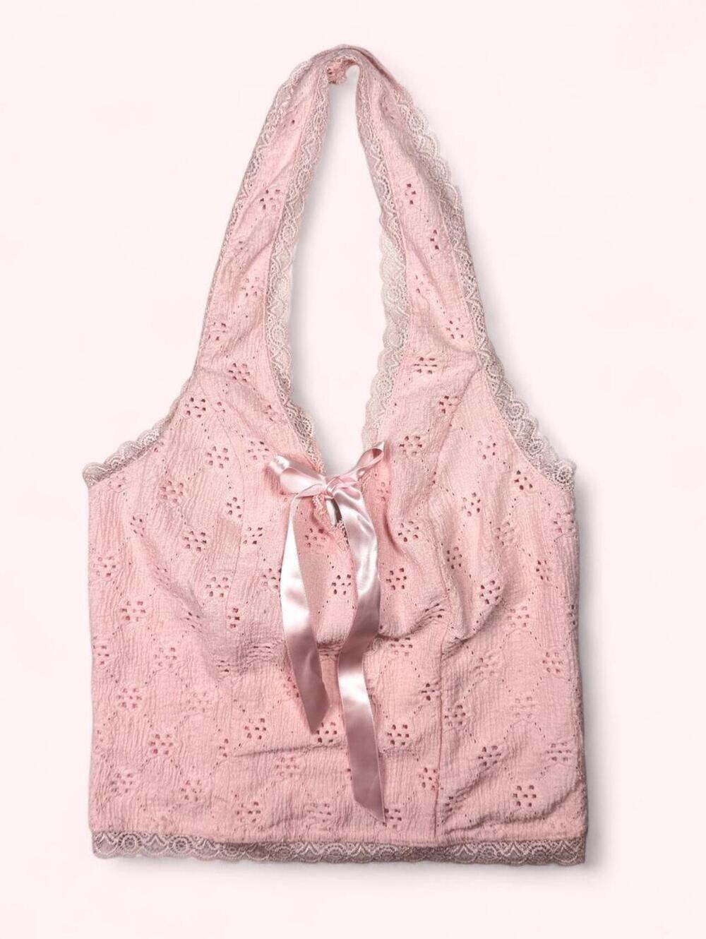 Pink halter top with bow detail and small floral embroidery
